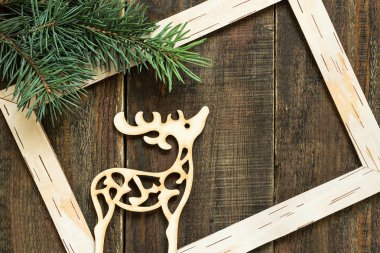 Fresh spruce branches, frame and Christmas decoration deer