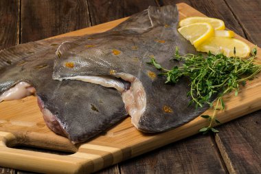 Fresh flounder prepared for cooking clipart