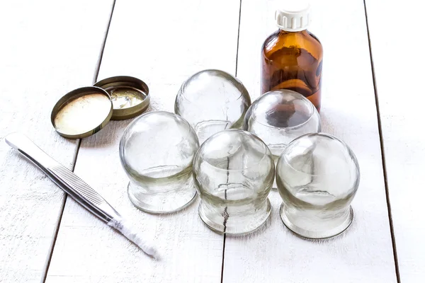 Старое медицинское стакан, алкоголь, бензин и пинцет — стоковое фото