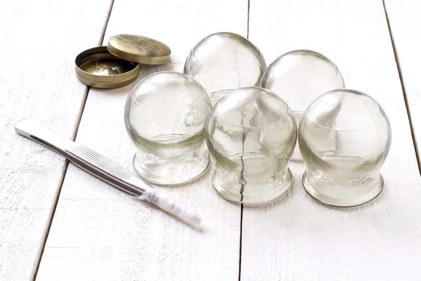 Old medical cupping glass, petrolatum and tweezers with cotton w — Stock Photo, Image