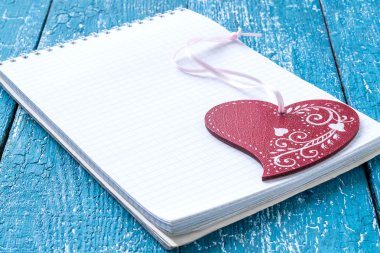 Notepad  and heart with ornament 