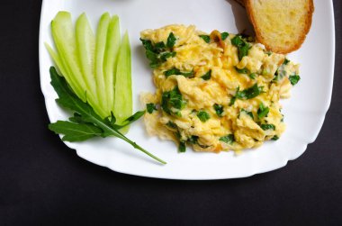 Beyaz tabakta ıspanaklı ve kızarmış ekmekli güzel bir omlet fotoğrafı. Metin için boş alanı olan gri bir arkaplanda. Yukarıdan görüntüle