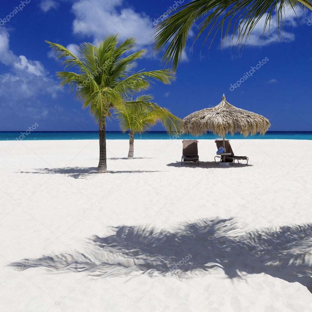 beach umbrella with loungers on the tropical island