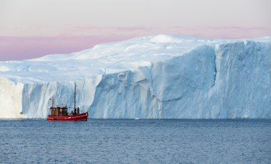 Ship against large iceberg clipart