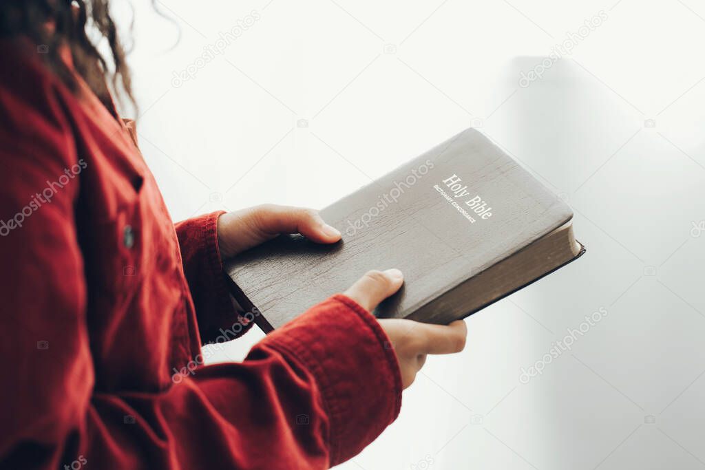 Close Up on a woman hands holding a bible.believe concept