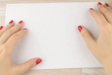 neat office work: Young worker with painted nails gently smoothes the envelope for further work