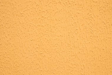 Soyut arkaplan: pürüzlü yüzeyli dekoratif alçı, turuncu dış çalışmalar için boyayla boyanmış.