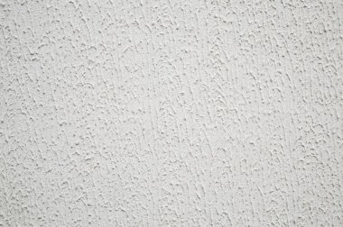 Soyut arkaplan: kaba bir yüzeye sahip dekoratif alçı, açık hava boyasıyla beyaz renge boyanmış.