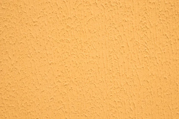 abstract background: Decorative plaster with rough surface, painted with paint for exterior works in orange