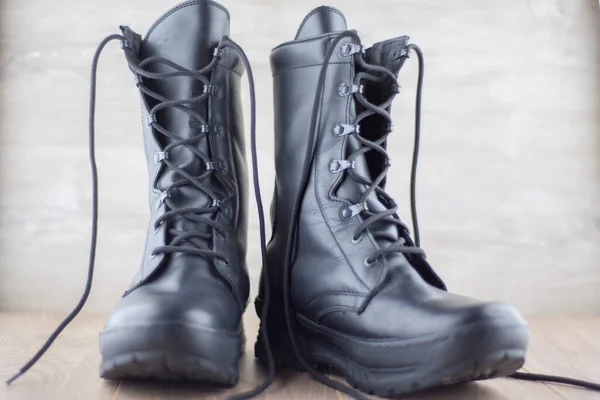 system of blocks for pinching the Russian military boots, a pair of shoes with signs of wear and dust