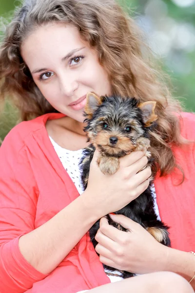 Mulher bela jovem feliz com cabelos longos segurando pequeno cão em — Fotografia de Stock