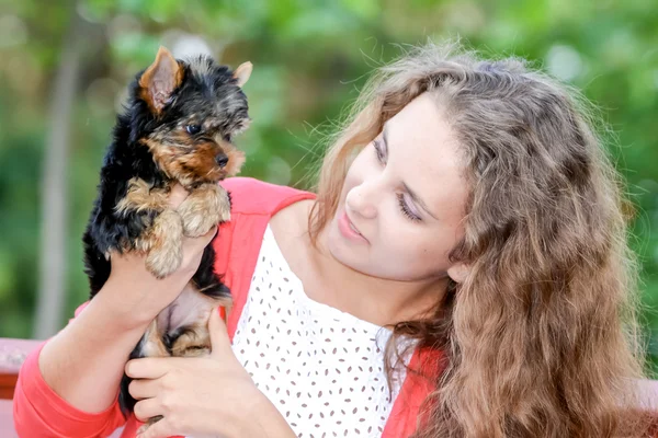 Kadın güzel genç uzun saçlı küçük köpek tutunarak mutlu — Stok fotoğraf