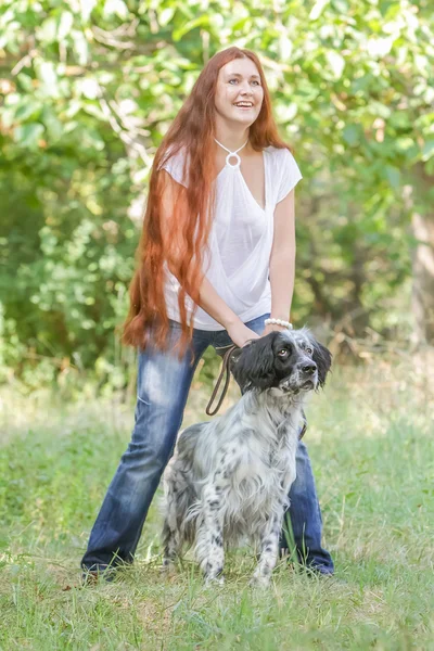 自然な表現の上に犬を持つ若い幸せな女性の屋外のポートレート — ストック写真