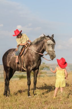 iki genç mutlu çocuklar bir çiftlikte, açık portre üzerinde binicilik