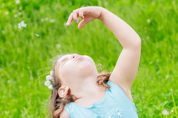 Schöne Kind Mädchen mit Löwenzahnblüte im Frühlingspark. glücklich — Stockfoto