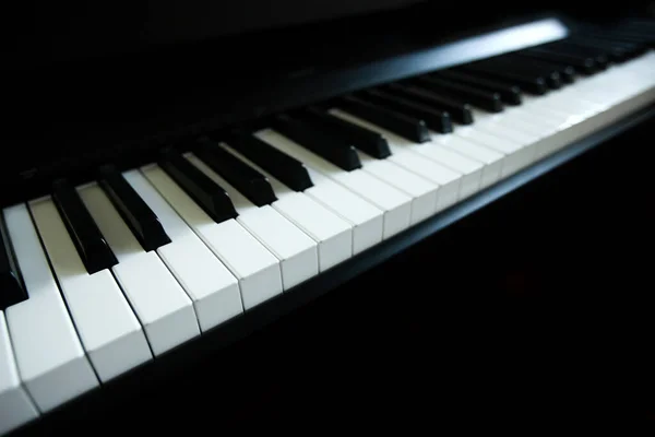 Acoustic or digital piano keyboard, black and white piano keys, music equipment — Stock Photo, Image