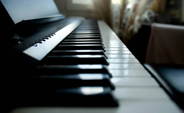 Acoustic or digital piano keyboard, black and white piano keys, music equipment — Stock Photo, Image