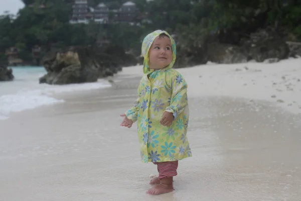 Cute baby under rain on sea background — Stock Photo, Image