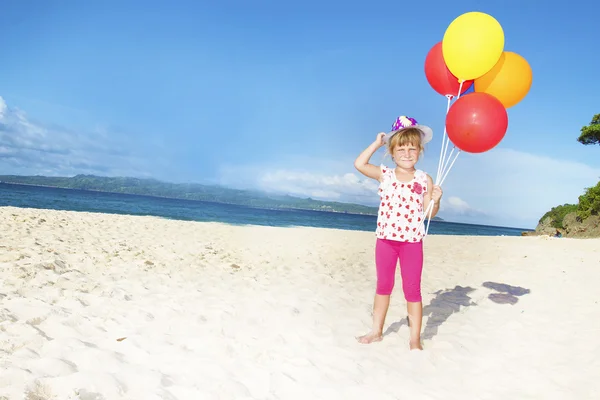 Outdoor portrait of young happy girl on sand beach on sea backgr — Stock Photo, Image