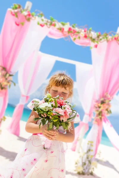 Young happy kid girl in beautiful dress on tropical wedding setu — Stock Photo, Image