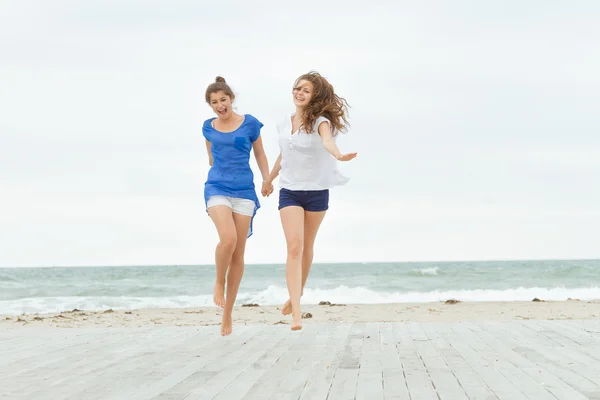 Two young happy women enjoying life outdoors isolated over white — Stock Photo, Image