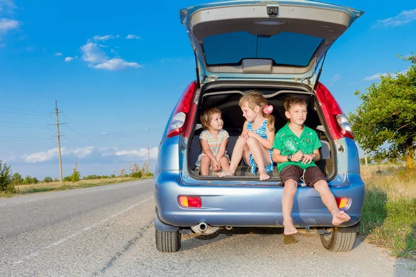 Three happy kids in car, family trip, summer vacation travel — Stock Photo, Image