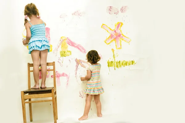 Two cute young child girls painting over white — Stock Photo, Image