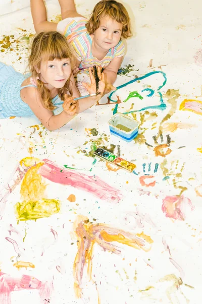 Two cute young child girls painting over white — Stock Photo, Image