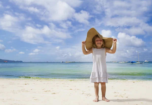 Young happy child girl in summer hat on tropical sea background — Stock Photo, Image