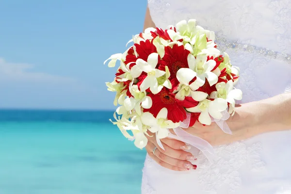 Bride holding bridal bouquet on natural sea background Royalty Free Stock Images