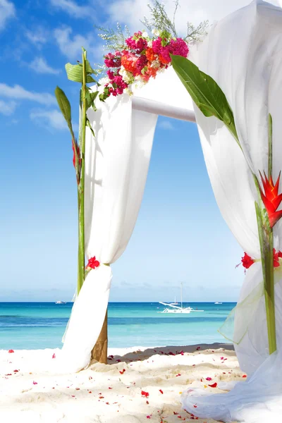 Wedding arch decarated with flowers on beach Stock Image