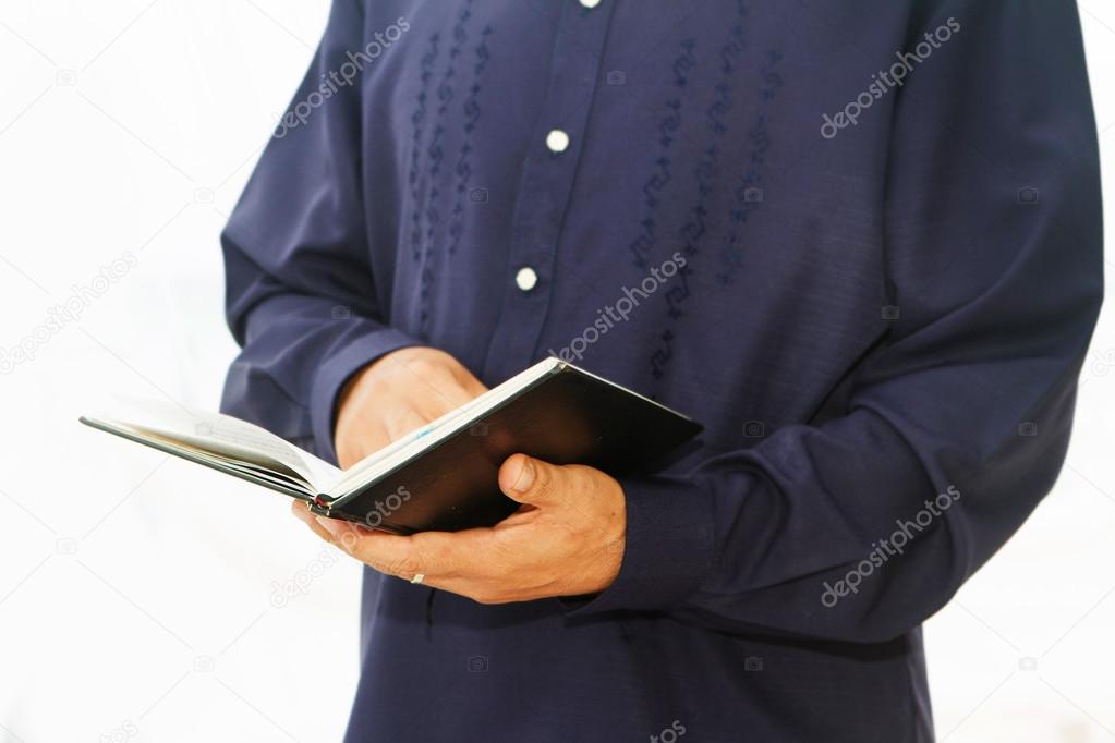 Pastor priest reading holy bible isolated over white