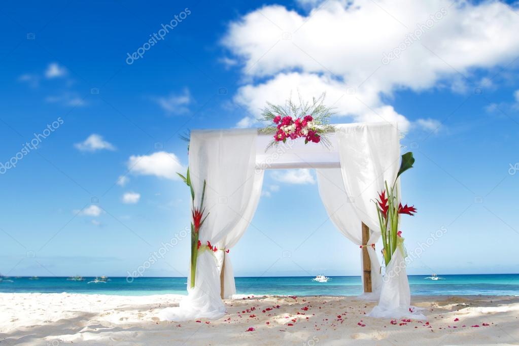 wedding arch decarated with flowers on beach