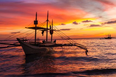 sail boat at sunset sea, boracay island, philippines clipart
