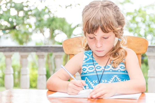 Young child girl writing in notebook, outdoors portrait, educati — Stock Photo, Image