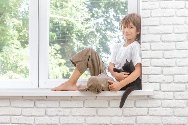 Indoor portrait of young happy smiing child boy with little blac — Stock Photo, Image