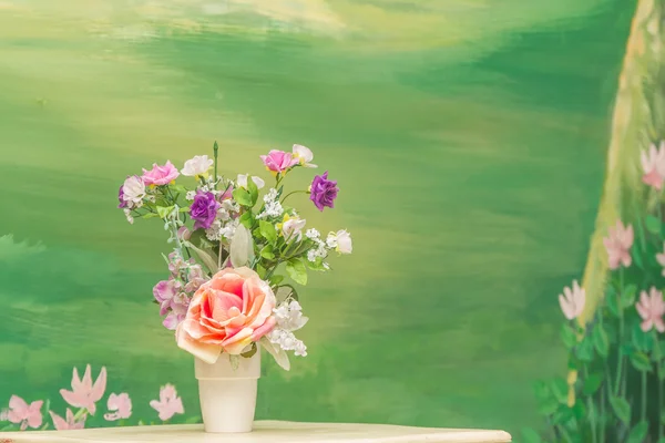 Artificial fake flower bouquet on blurred green background — Stock Photo, Image