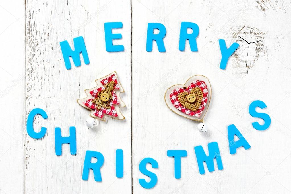 merry christmas words and decoration on wooden background