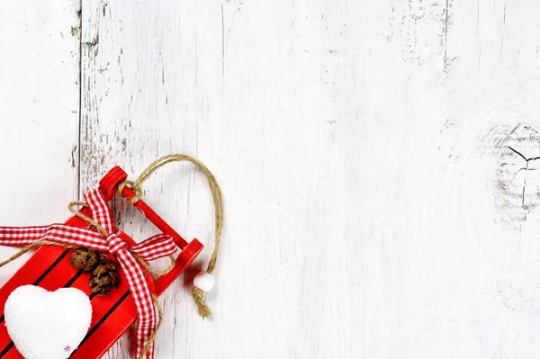 Christmas tree decoration - sled on wooden background — Stock Photo, Image