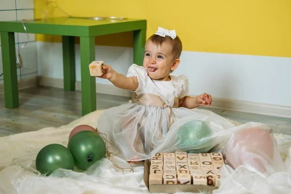 Sustainable eco-friendly safe wooden toys for baby and kids. Baby girl play with wooden blocks made with organic, renewable eco-friendly materials