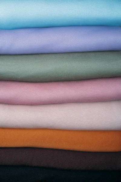 Stack of Pastel natural color Fabrics on white background. Fabrics And Clothing Arranged In Neat Stacks. Fabrics pile background — Stock Photo, Image