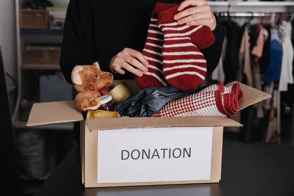 Donation box, Charity Gift hampers, Help Refugees and homeless. Christmas Xmas Charity Donation box with warm clothes, food and toys at home. Charities giving winter hampers to families in need