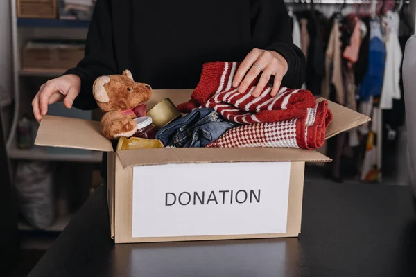 Donation box, Charity Gift hampers, Help Refugees and homeless. Christmas Xmas Charity Donation box with warm clothes, food and toys at home. Charities giving winter hampers to families in need