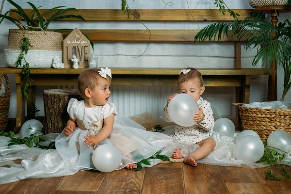 Cute little baby toddler princess at first birthday party at home. 1st Birthday home party ideas with natural decoration. Sustainable eco-friendly baby birthday at home
