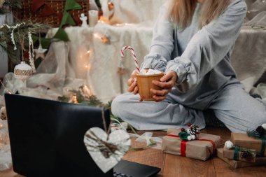 Sanal Noel partisi, Noel partileri yeni normal sosyal mesafelerde çevrimiçi oluyor, evde gerçeklik kalıyor. Laptop 'ın yanındaki kadın Noel için çevrimiçi tatil kutlaması için hazır..