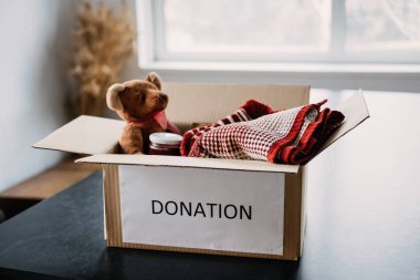 Donation box, Charity Gift hampers, Help Refugees and homeless. Christmas Xmas Charity Donation box with warm clothes, food and toys at home. Charities giving winter hampers to families in need clipart