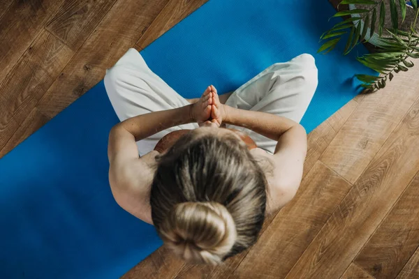 Perawatan diri, kasih sayang diri sendiri, kesejahteraan mental di dunia pasca-pandemi. Kesehatan mental, kesejahteraan, meditasi untuk menghilangkan kecemasan. Wanita muda yang duduk di lantai melakukan latihan yoga dan meditasi di rumah — Stok Foto