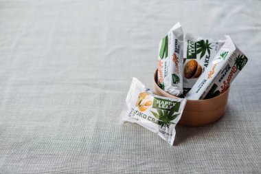 CBD Yenilebilir, CBD Enfüzyonlu Atıştırmalıklar, kekler, kenevirli gofretler. Doğal arkaplanda keten kumaştan yapılmış kase içinde lezzetli CBD çerezleri. Kropivnitskiy, Ukrayna, 20 Eylül 2020