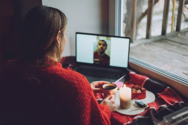 Woman using online dating app on laptop. Valentines Day, dating, meeting During The Coronavirus Outbreak. Love at distance in the time of coronavirus.