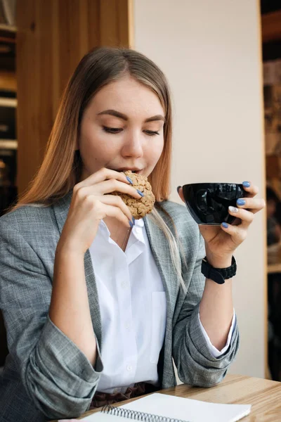 Food to Boost Brain and Memory, brainpower, nutrients for brain function. Girl student studying in cafe with cookies and hot drink